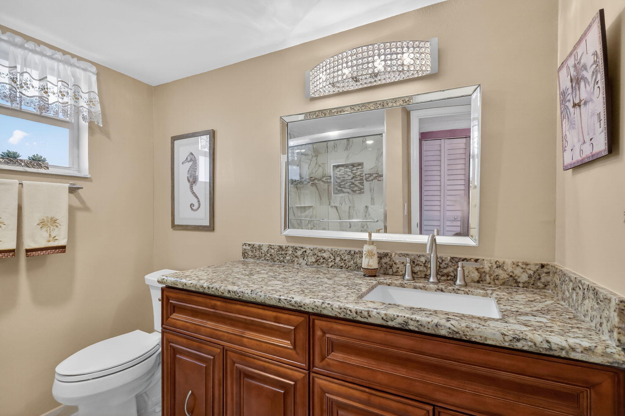 12 Colonial Club Drive, Unit 305 Boynton Beach, FL 33435 - Photo 19 of 51 a bathroom with a granite countertop sink a toilet and a mirror