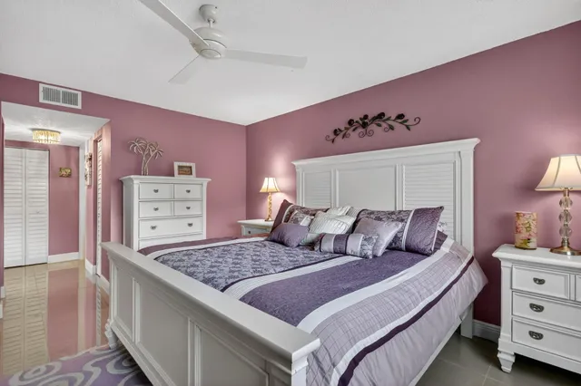 a large bedroom with a bed and a mirror