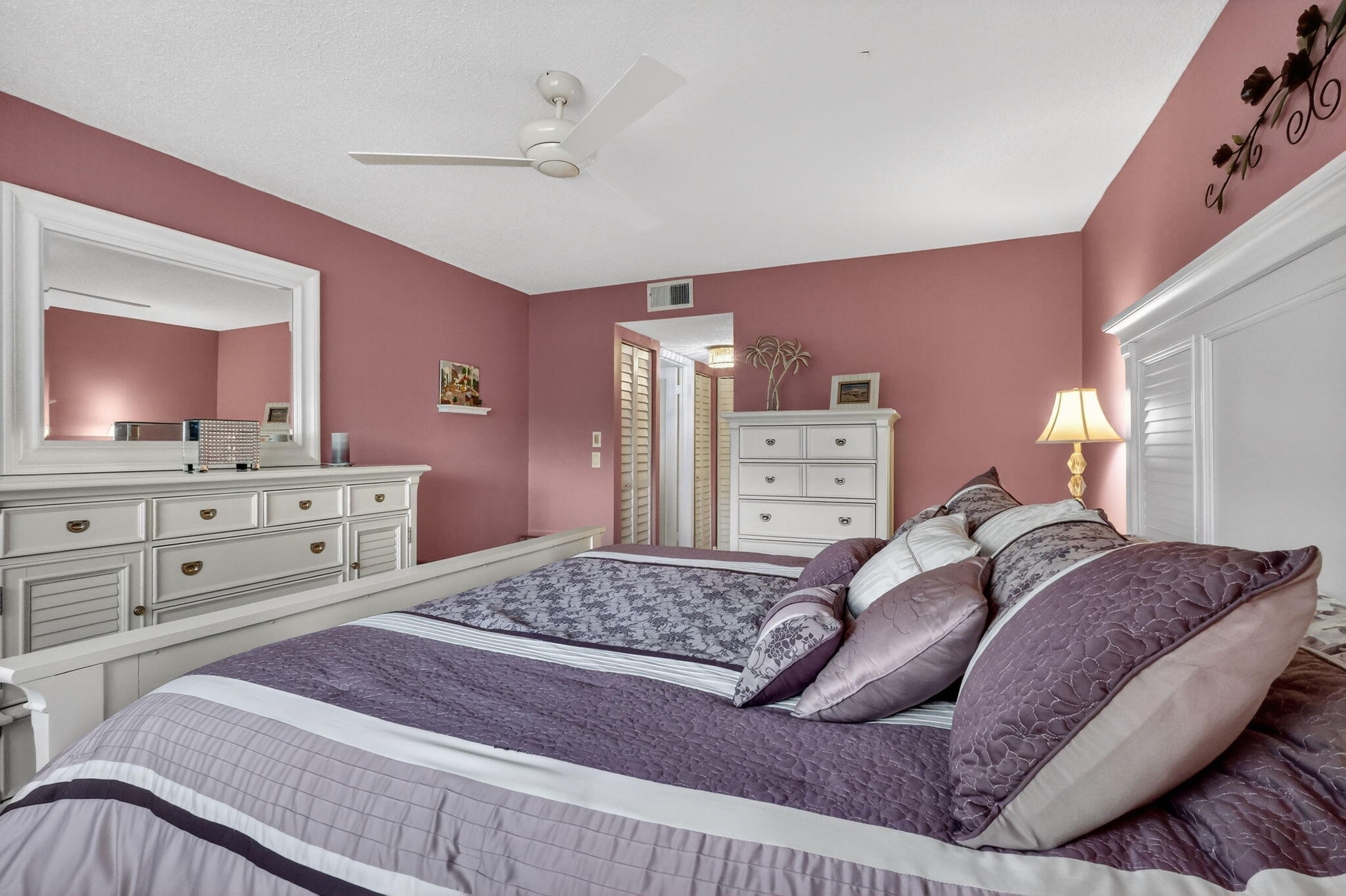 12 Colonial Club Drive, Unit 305 Boynton Beach, FL 33435 - Photo 24 of 51 a large bedroom with a bed and a mirror