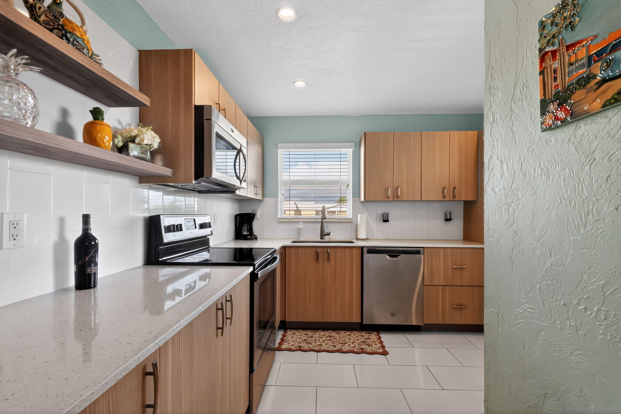 12 Colonial Club Drive, Unit 305 Boynton Beach, FL 33435 - Photo 25 of 51 a kitchen with stainless steel appliances a sink and cabinets