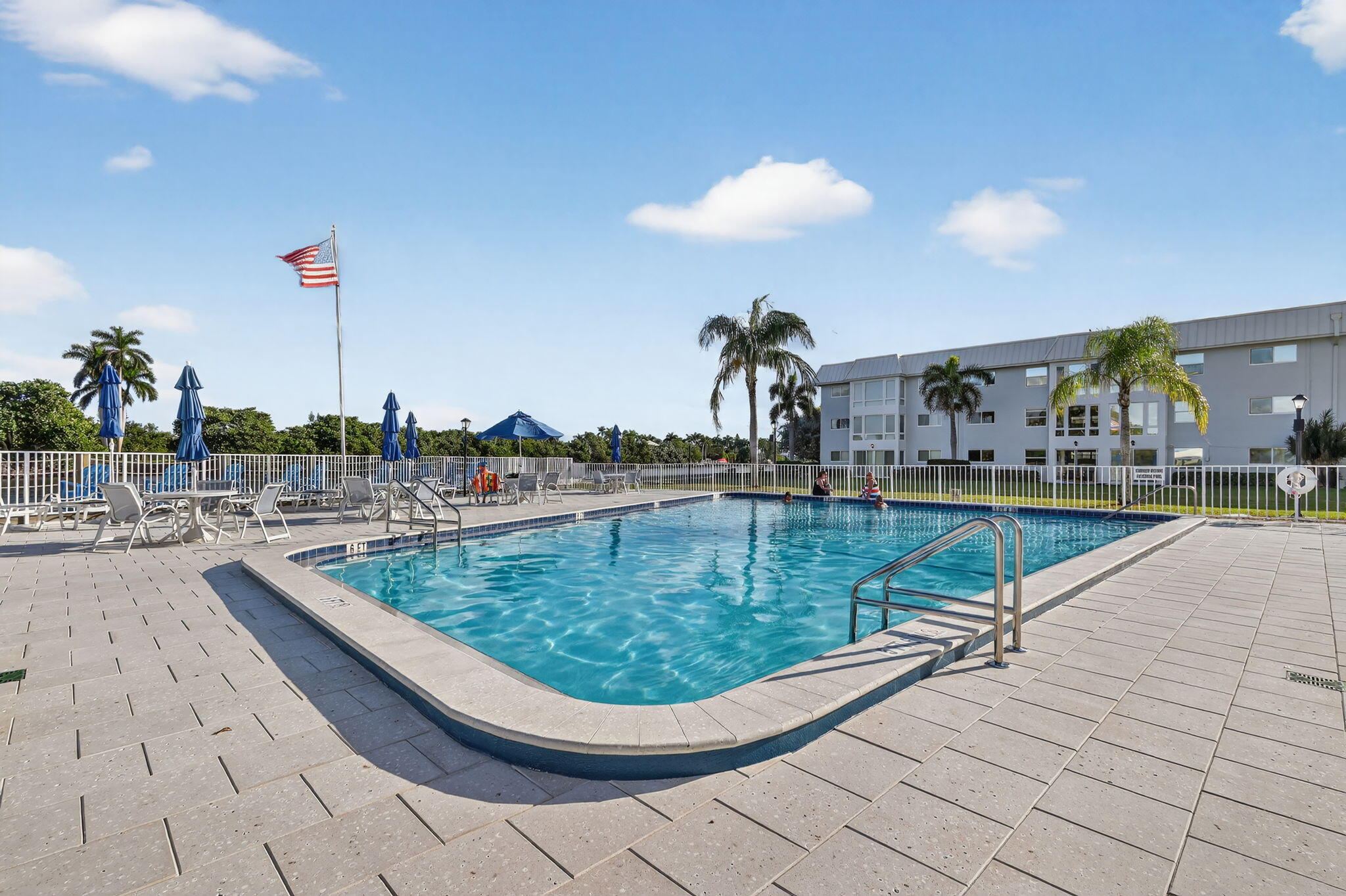 12 Colonial Club Drive, Unit 305 Boynton Beach, FL 33435 - Photo 48 of 51 a view of a swimming pool with outdoor seating