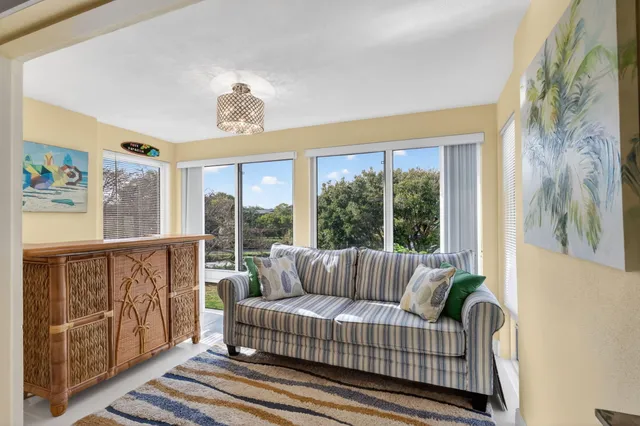 a living room with furniture wooden floor and a flat screen tv