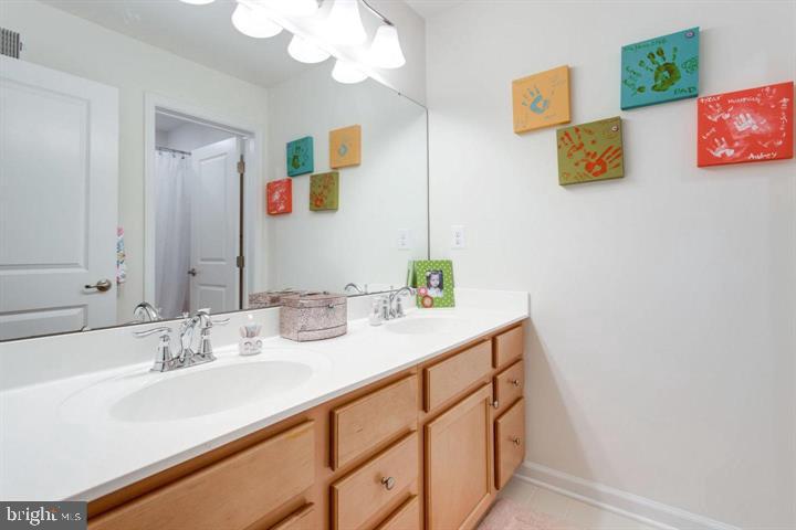 41663 McMonagle Square Aldie, VA 20105 - Photo 15 of 22 a bathroom with a sink and a mirror