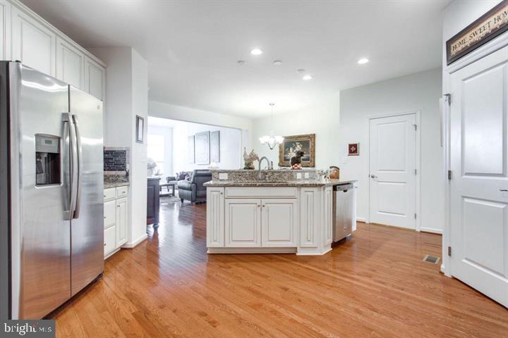 41663 McMonagle Square Aldie, VA 20105 - Photo 2 of 22 a kitchen with stainless steel appliances granite countertop a refrigerator and a stove top oven
