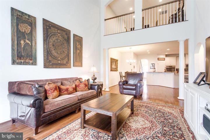 41663 McMonagle Square Aldie, VA 20105 - Photo 3 of 22 a living room with furniture and a painting on the wall
