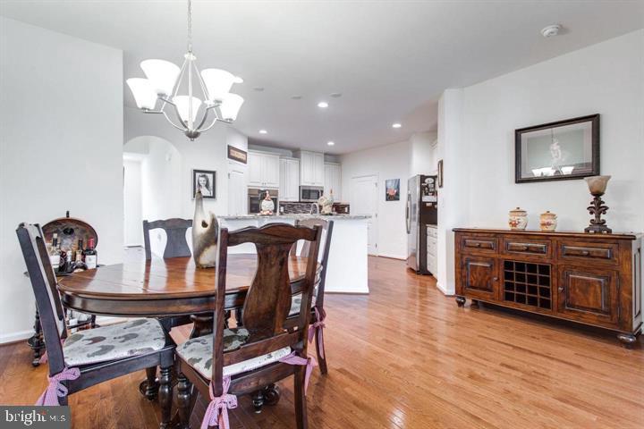 41663 McMonagle Square Aldie, VA 20105 - Photo 6 of 22 a view of a dining room with furniture and wooden floor