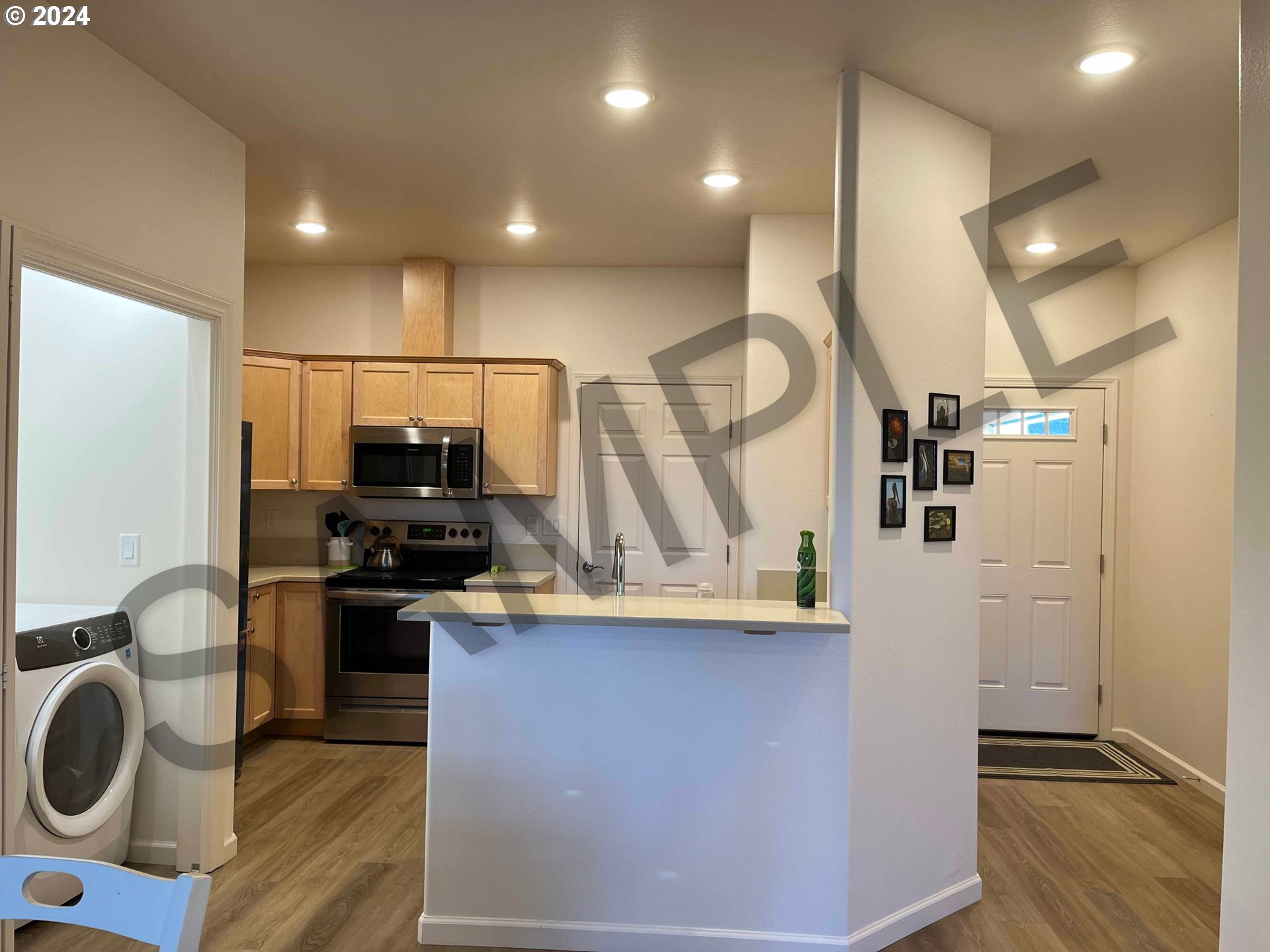 1591 37th Street Florence, OR 97439 - Photo 16 of 48 a kitchen with stainless steel appliances granite countertop a sink a stove and a refrigerator