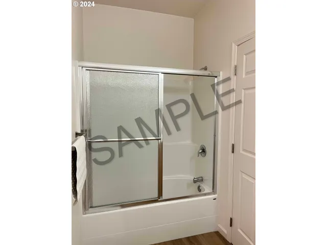 an aerial view of multiple houses with a yard