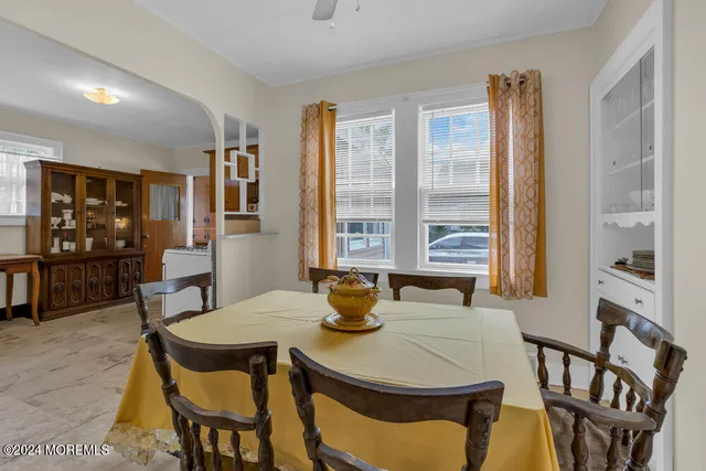 a view of a dining room with furniture and window