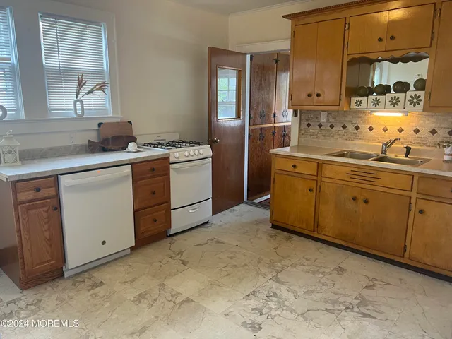 a kitchen with sink and cabinets