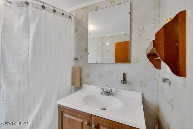 a bathroom with a sink vanity and mirror
