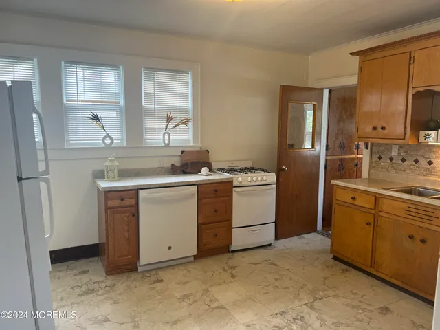 a kitchen with a stove sink and refrigerator