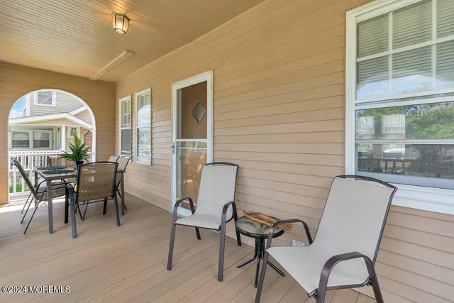 a view of a dining room with furniture and windows
