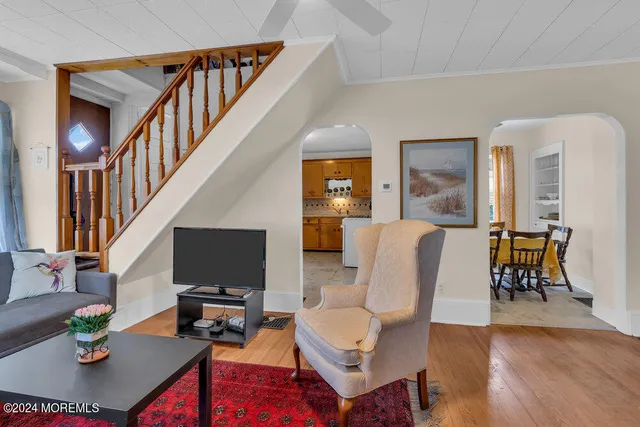 a living room with furniture a rug and a flat screen tv