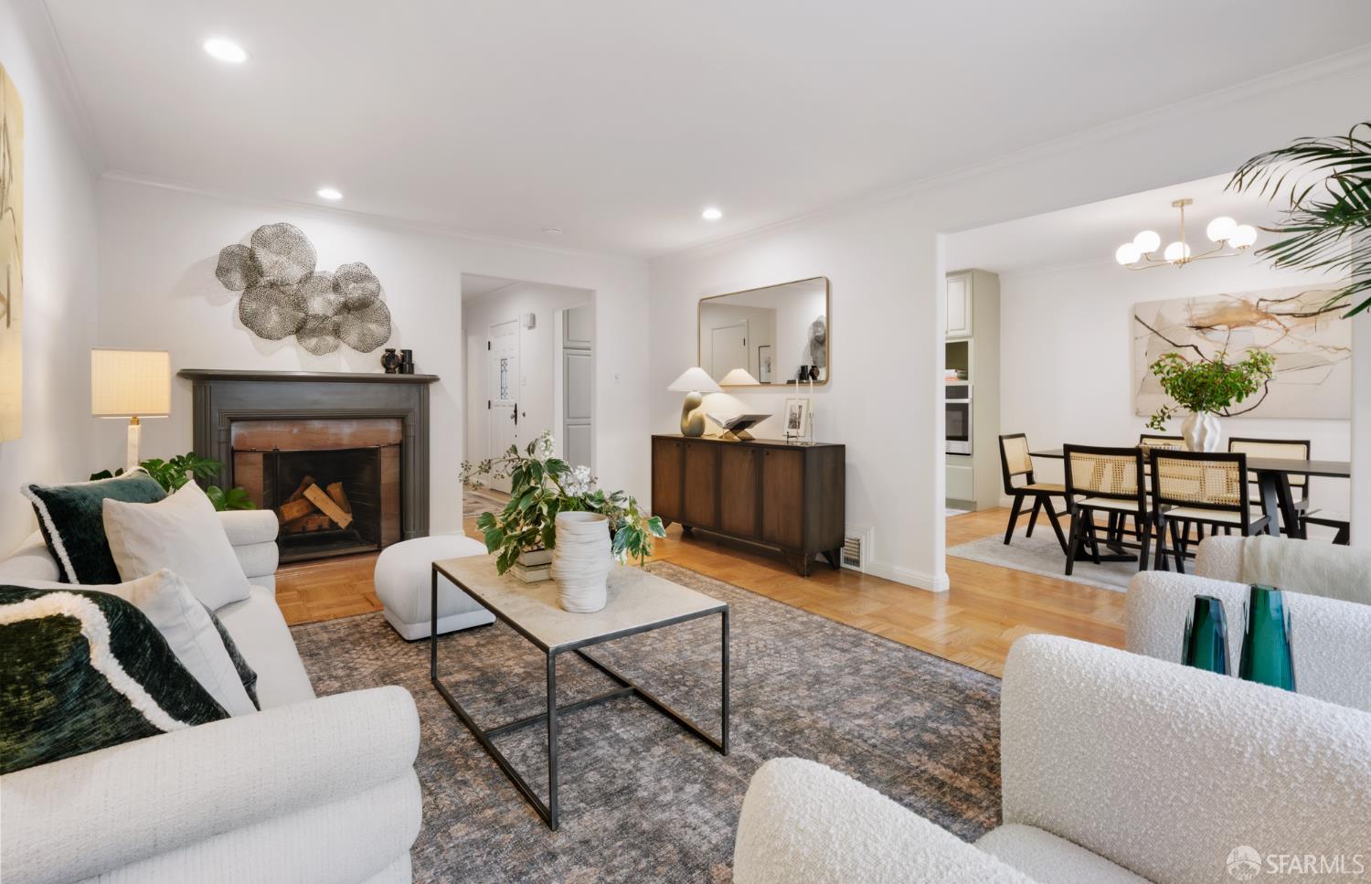 1768 Jackson Street San Francisco, CA 94109 - Photo 5 of 33 a living room with furniture a fireplace and a chandelier