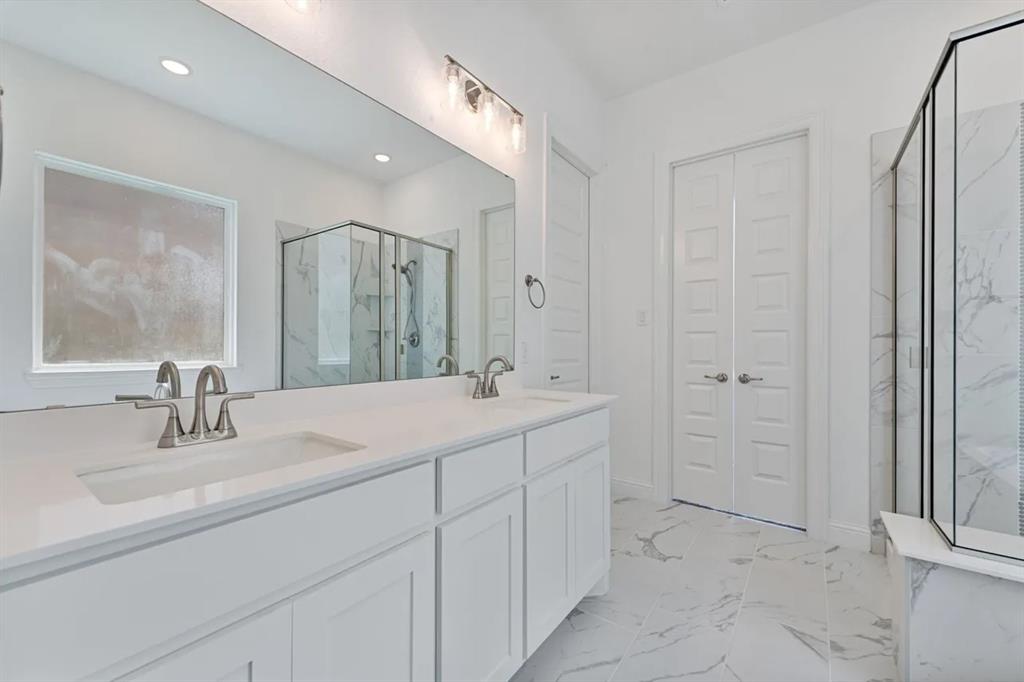 9337 Loggerhead Way Fort Worth, TX 76118 - Photo 27 of 40 a bathroom with a sink and a mirror