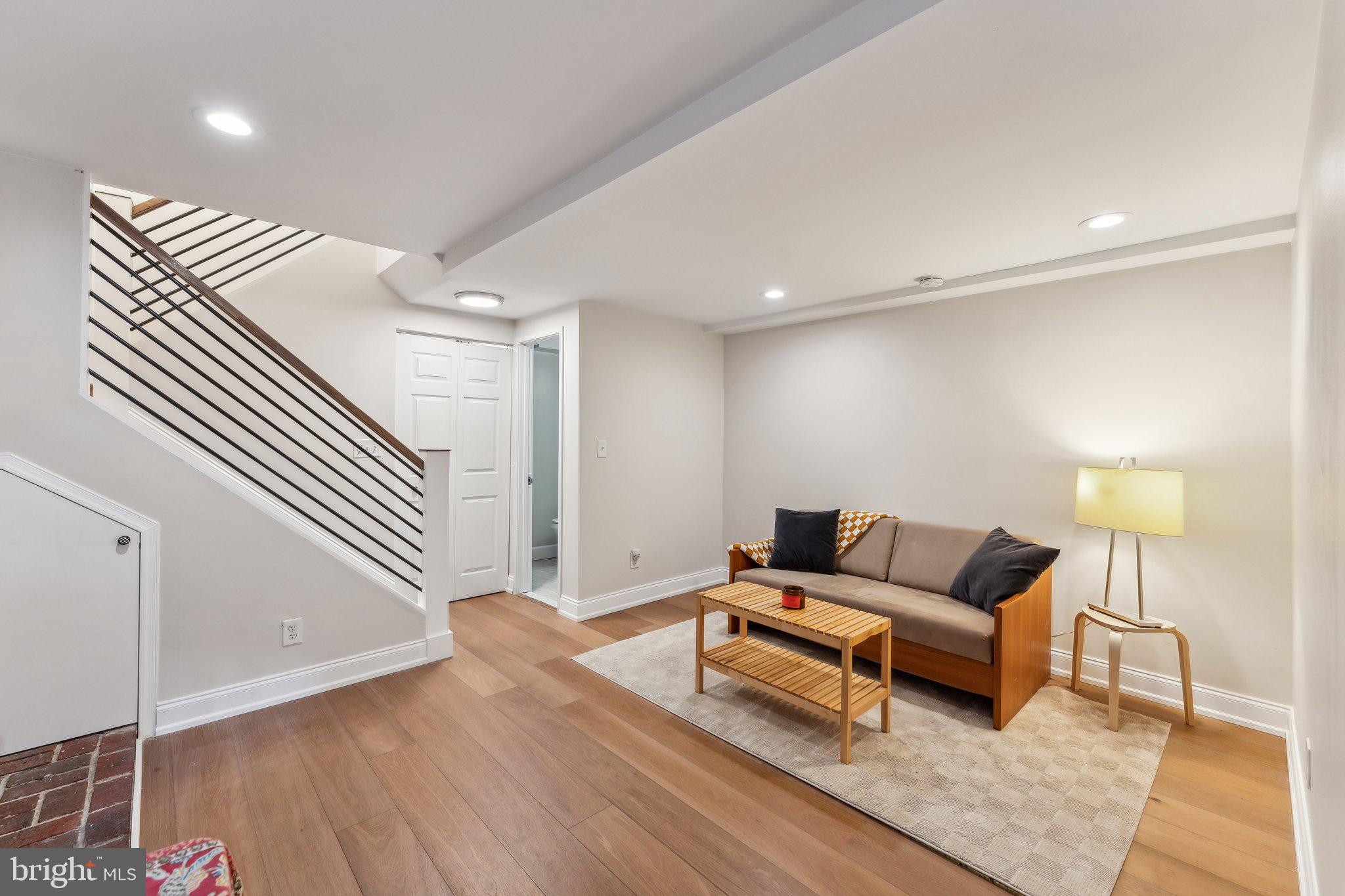 1844 Columbia Road Northwest, Unit 103 Washington, DC 20009 - Photo 11 of 21 a living room with furniture and a wooden floor