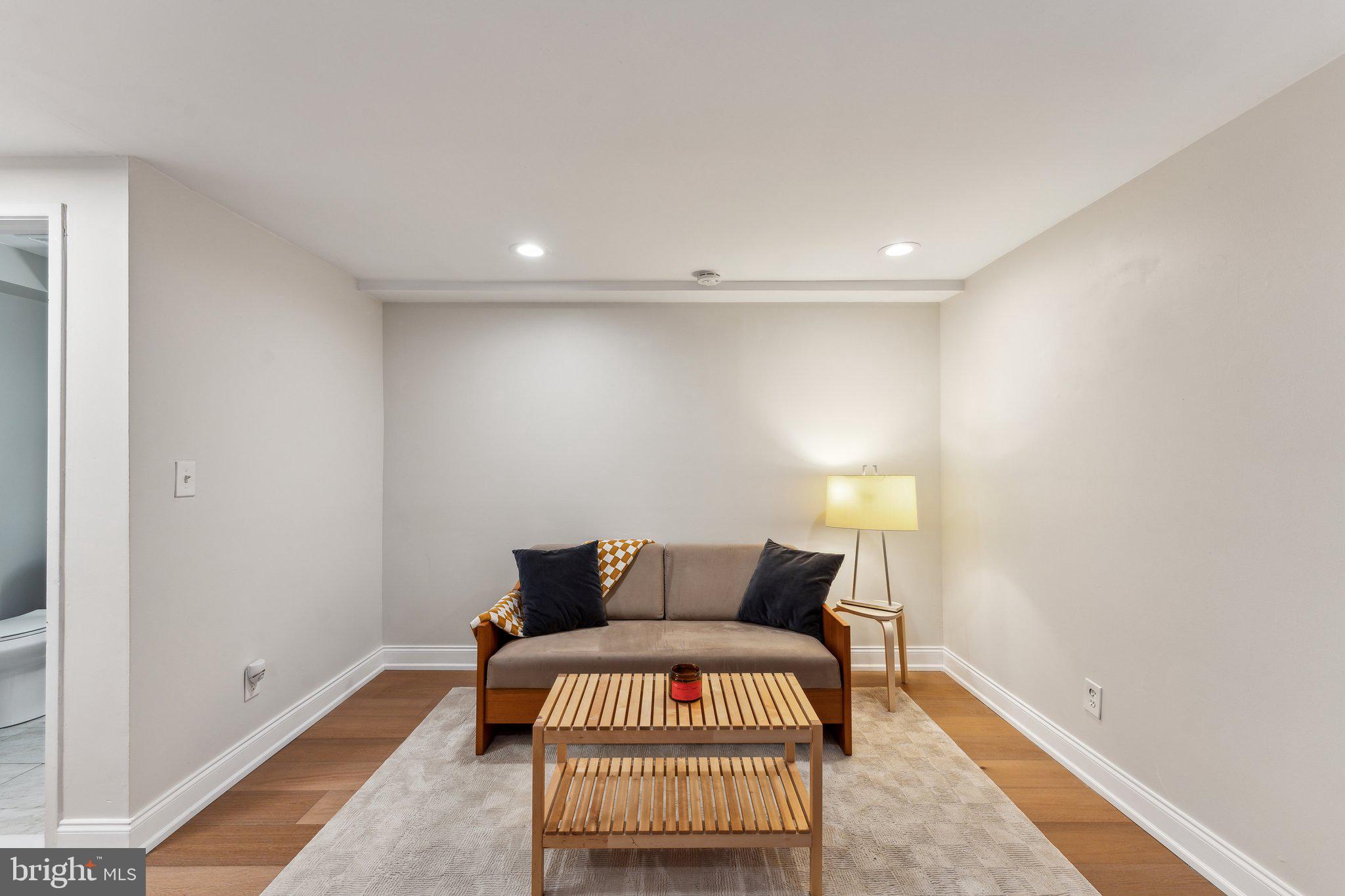1844 Columbia Road Northwest, Unit 103 Washington, DC 20009 - Photo 12 of 21 a bedroom with a bed and a night stand