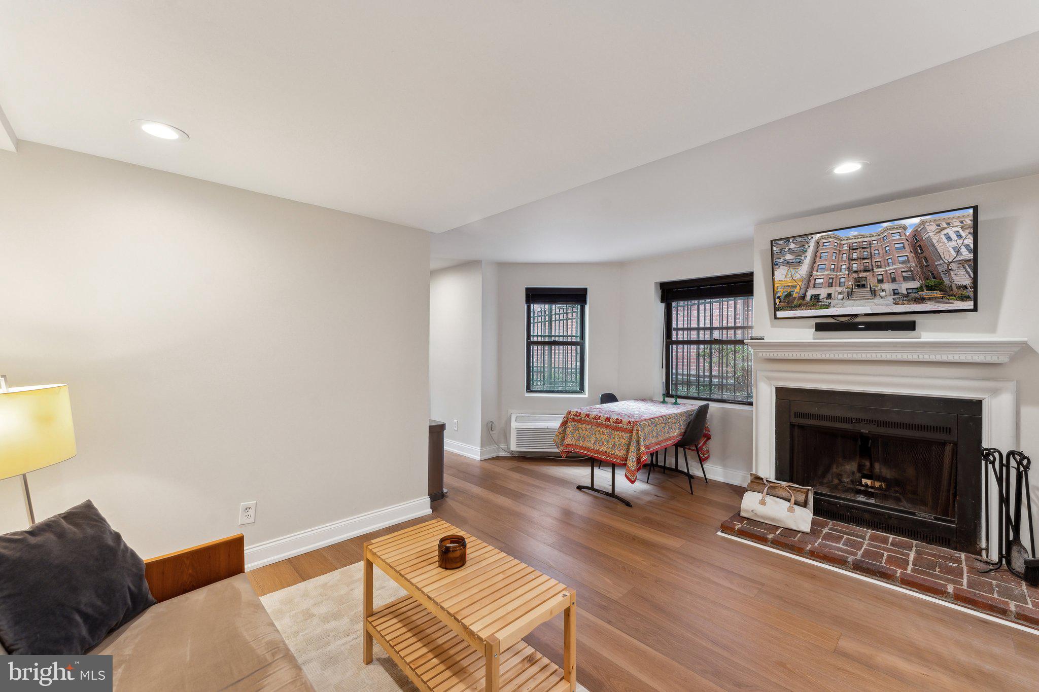 1844 Columbia Road Northwest, Unit 103 Washington, DC 20009 - Photo 13 of 21 a living room with furniture and a fireplace