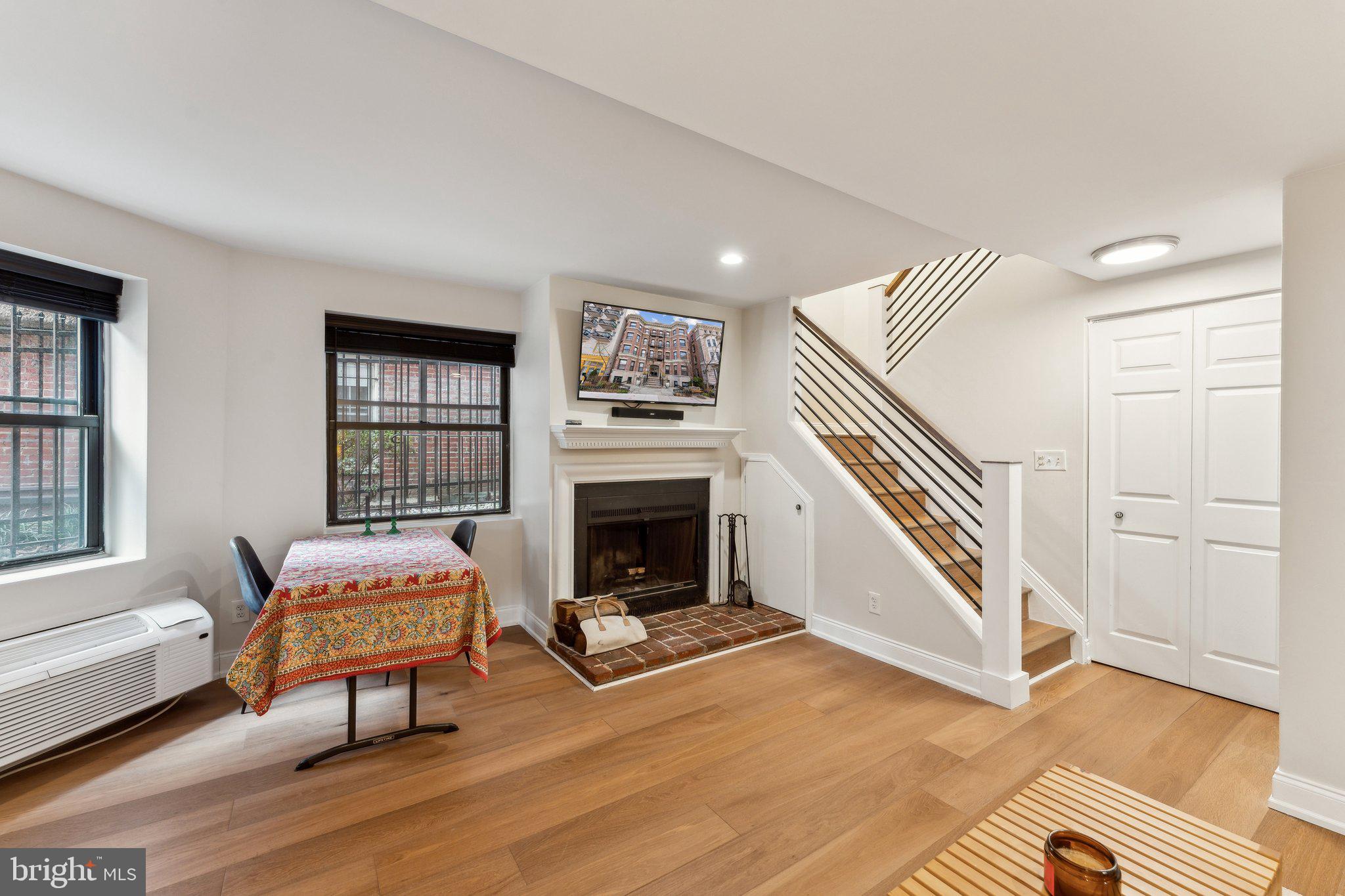 1844 Columbia Road Northwest, Unit 103 Washington, DC 20009 - Photo 14 of 21 a living room with furniture and a fireplace