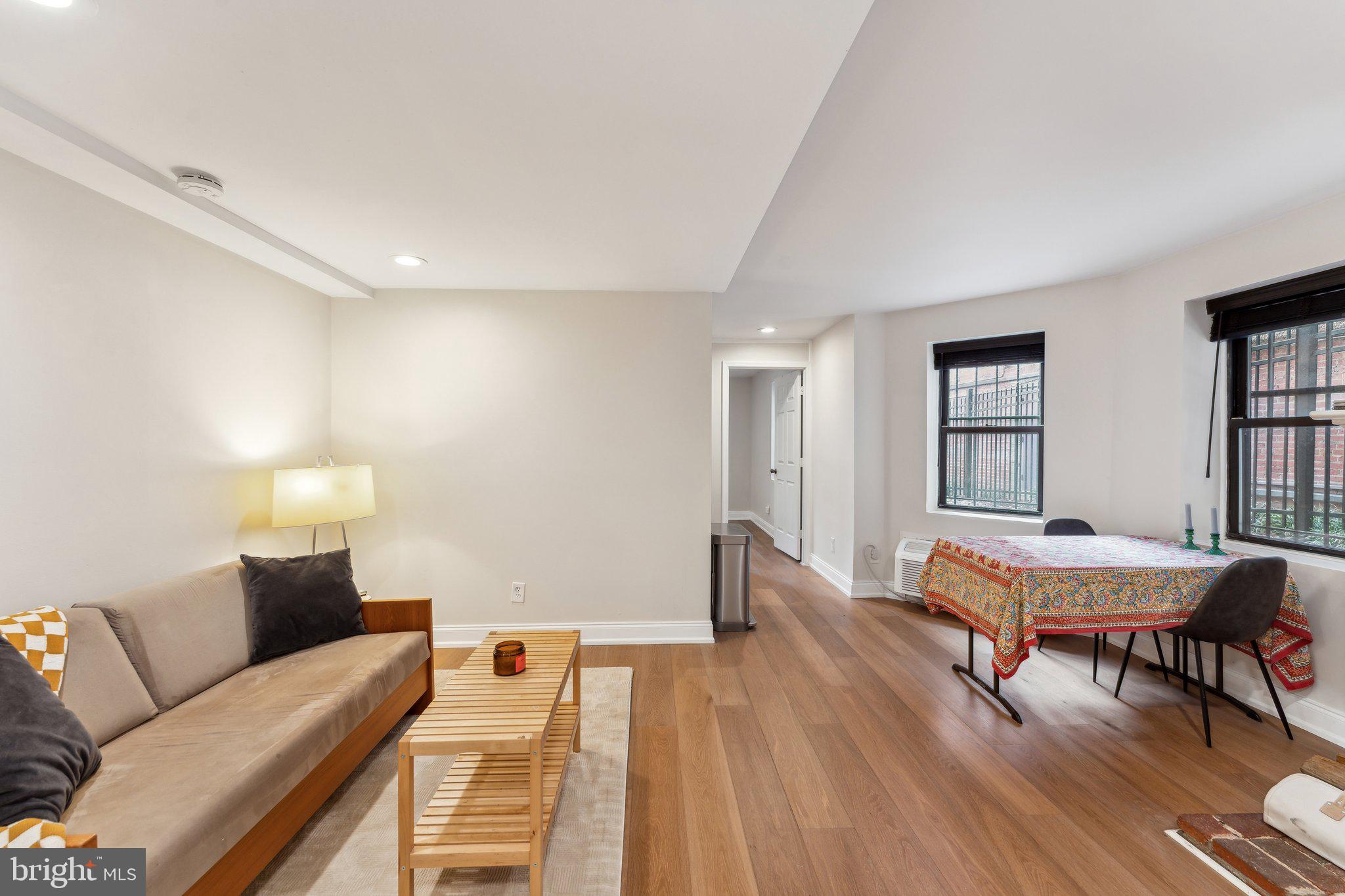 1844 Columbia Road Northwest, Unit 103 Washington, DC 20009 - Photo 15 of 21 a living room with furniture and wooden floor