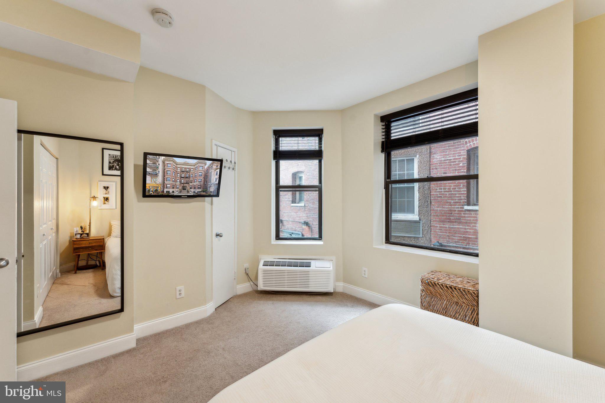 1844 Columbia Road Northwest, Unit 103 Washington, DC 20009 - Photo 4 of 21 a bedroom with a bed and a window