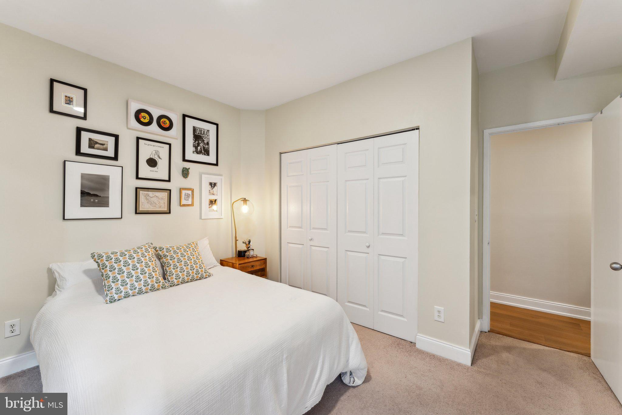 1844 Columbia Road Northwest, Unit 103 Washington, DC 20009 - Photo 5 of 21 a bedroom with a large bed and painting on the wall