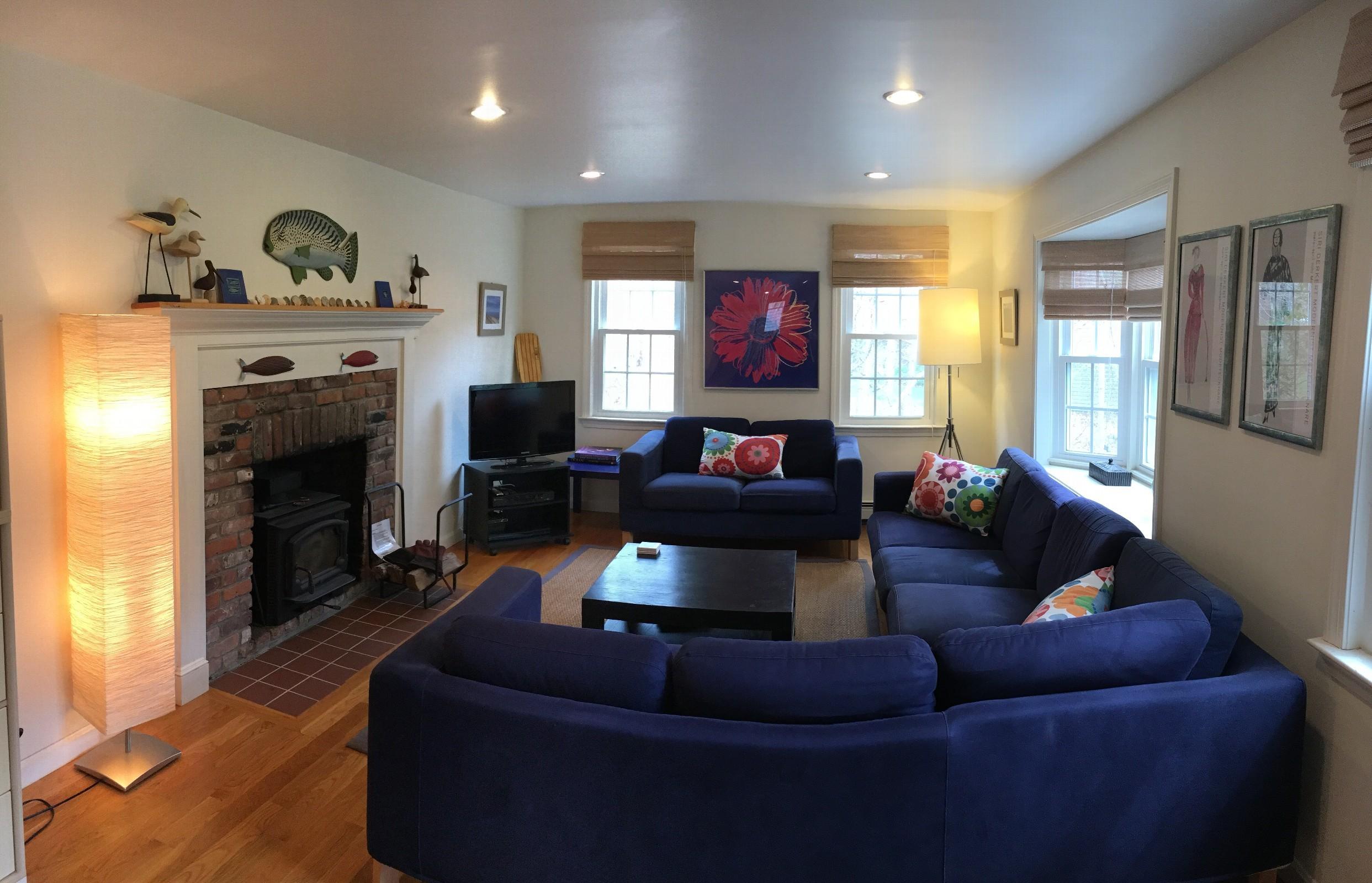 70 Browns Neck Road Wellfleet, MA 02667 - Photo 3 of 12 a living room with furniture a fireplace and a flat screen tv