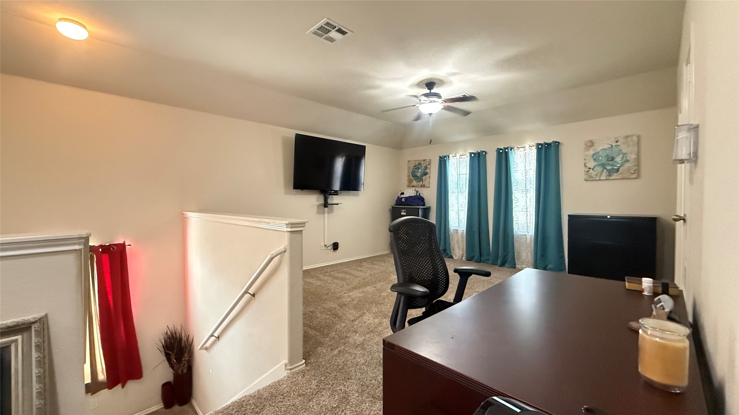 18309 Wind Tree Lane Elgin, TX 78621 - Photo 26 of 29 Soft carpeting anchors this versatile upper level space featuring recessed lighting and a classic banister.