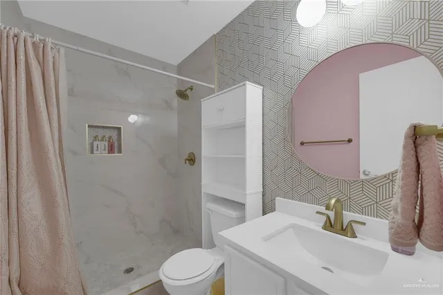 a bathroom with a sink toilet and shower