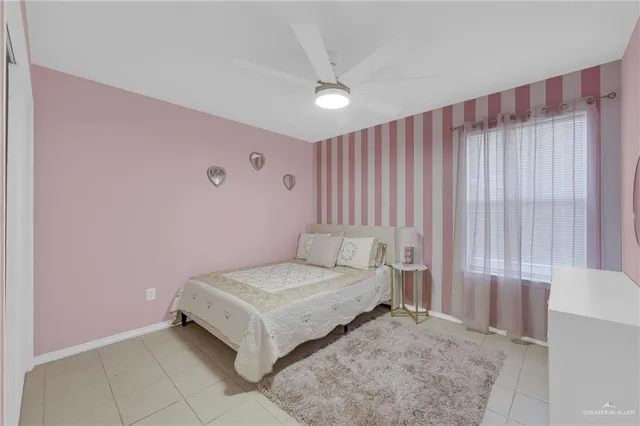 a spacious bedroom with a bed and a table in it