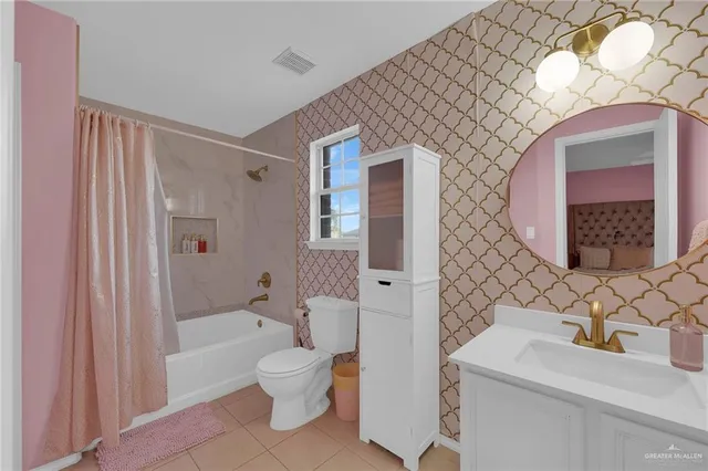 a bathroom with a sink toilet vanity and shower