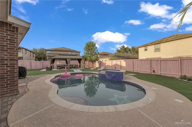 a view of a swimming pool with a yard