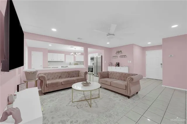 a living room with furniture and a view of kitchen