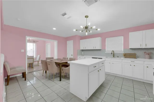 a kitchen with a sink counter top space appliances and cabinets