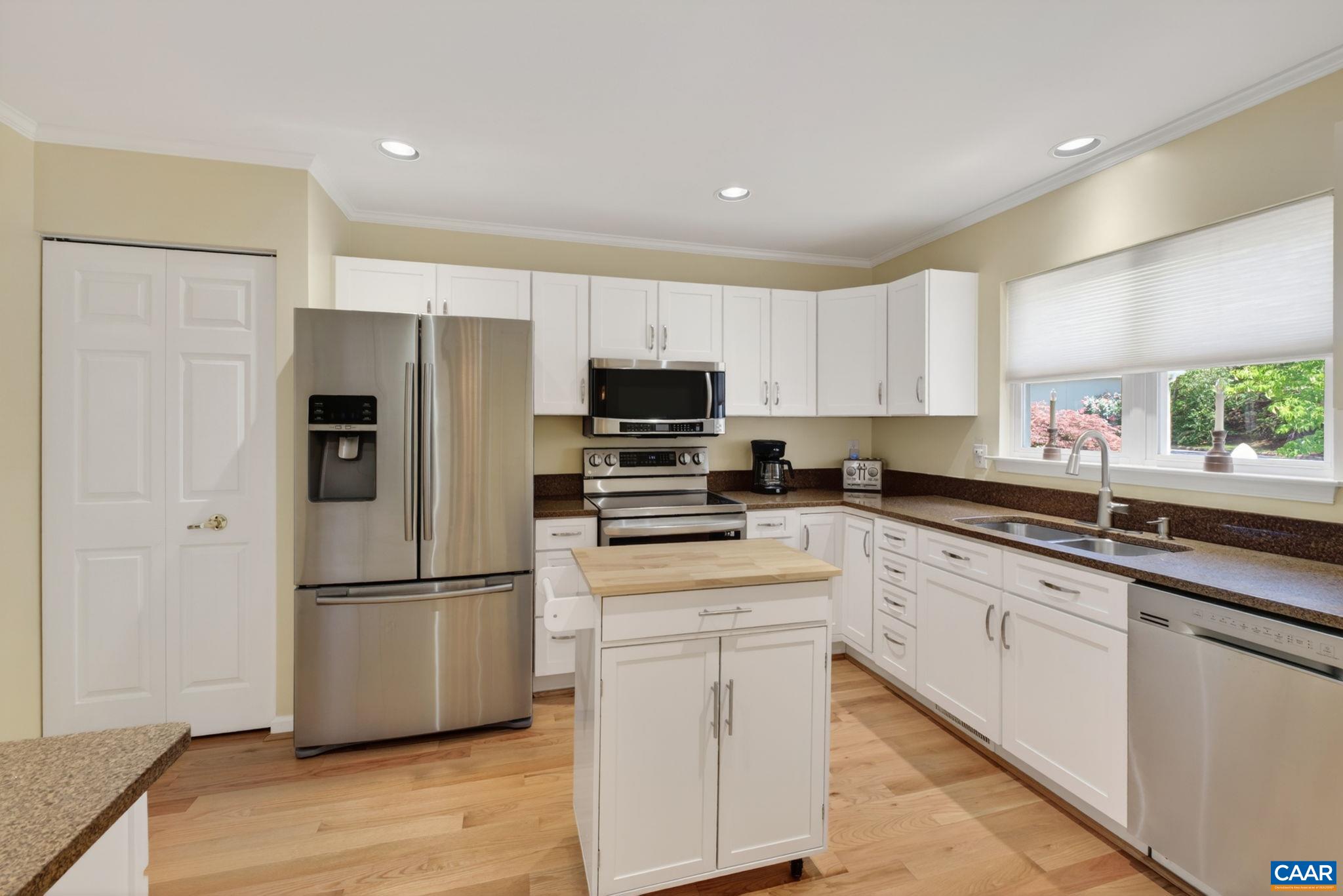 590 Mockingbird Way Charlottesville, VA 22901 - Photo 17 of 43 a kitchen with white cabinets and stainless steel appliances