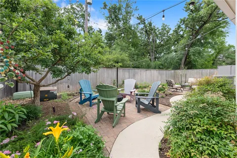 a view of a backyard with sitting area and garden