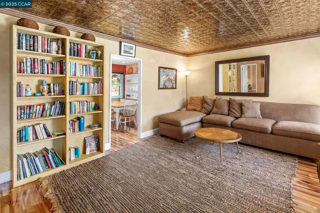 a living room with furniture a flat screen tv and a window