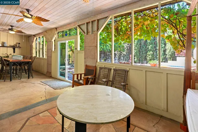 a view of a patio with table and chairs and potted plants