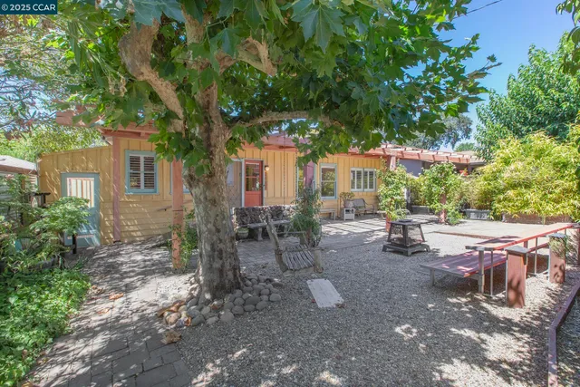 a view of a house with backyard porch and sitting area
