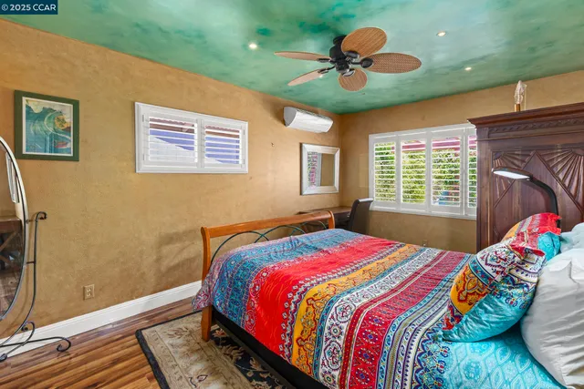 a bedroom with a bed and flat screen tv