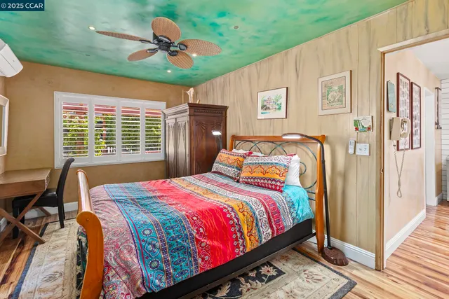 a bedroom with a large bed and a window