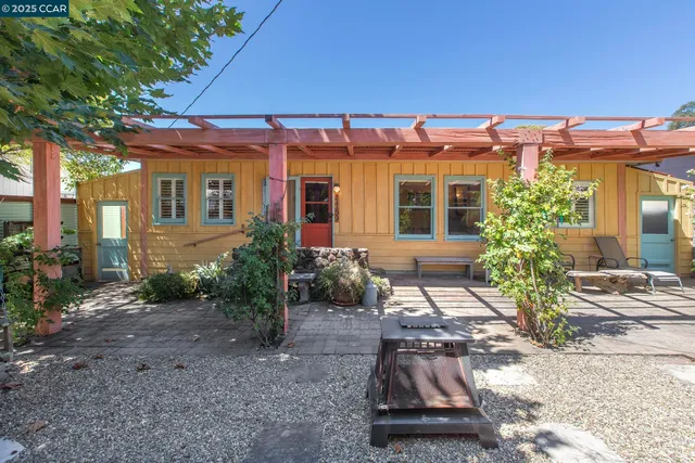 a view of a house with a small yard and floor to ceiling window
