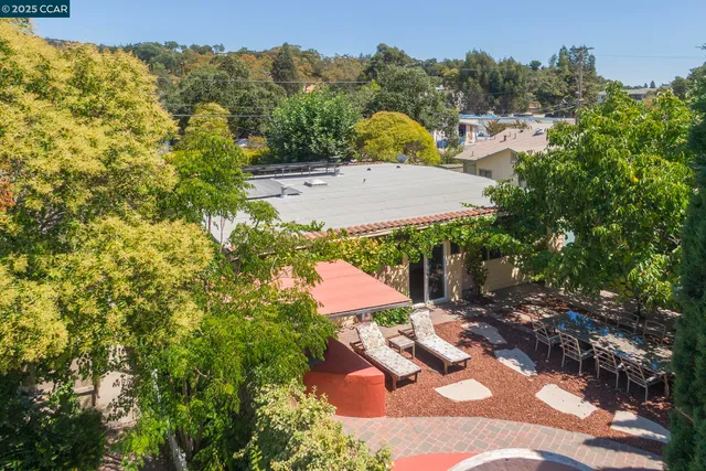 an aerial view of multiple house with yard and parking