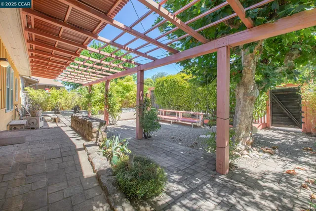 a view of a patio with table and chairs and potted plants
