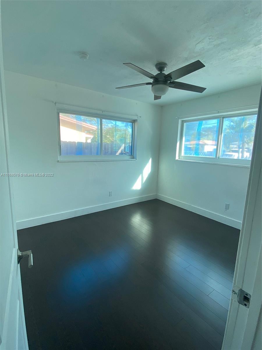 6561 Southwest 30th Street, Unit FRONT Miami, FL 33155 - Photo 13 of 18 an empty room with a window and a ceiling fan