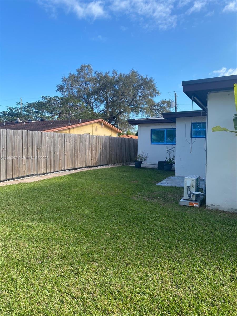 6561 Southwest 30th Street, Unit FRONT Miami, FL 33155 - Photo 16 of 18 a view of a backyard with a garden and deck