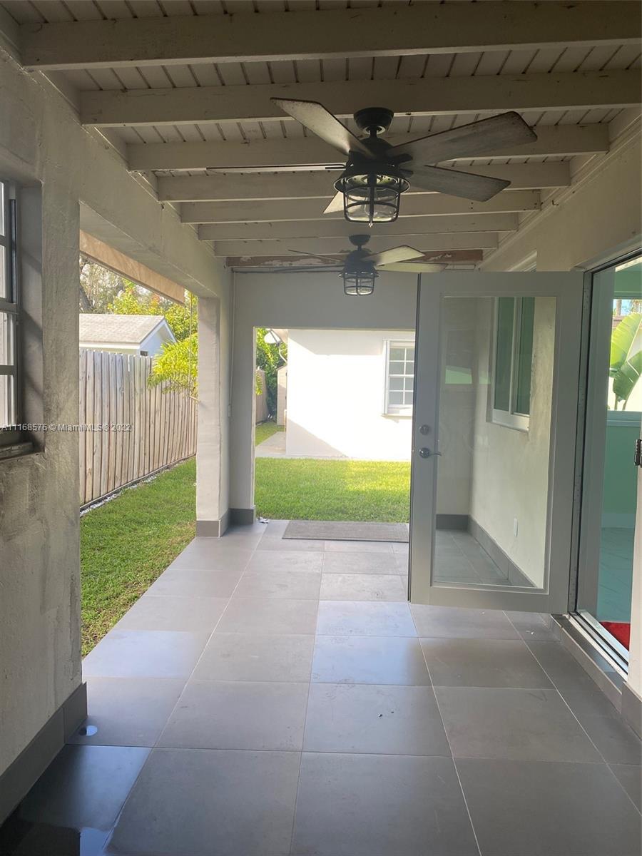 6561 Southwest 30th Street, Unit FRONT Miami, FL 33155 - Photo 17 of 18 a view of a livingroom with a patio and a yard