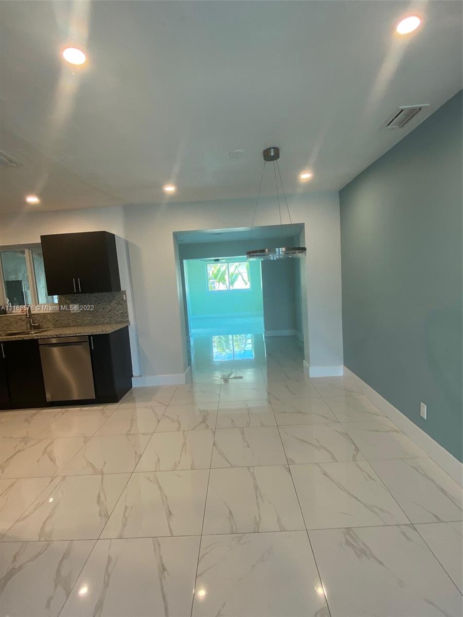 6561 Southwest 30th Street, Unit FRONT Miami, FL 33155 - Photo 2 of 18 a view of a kitchen with a sink and a fireplace