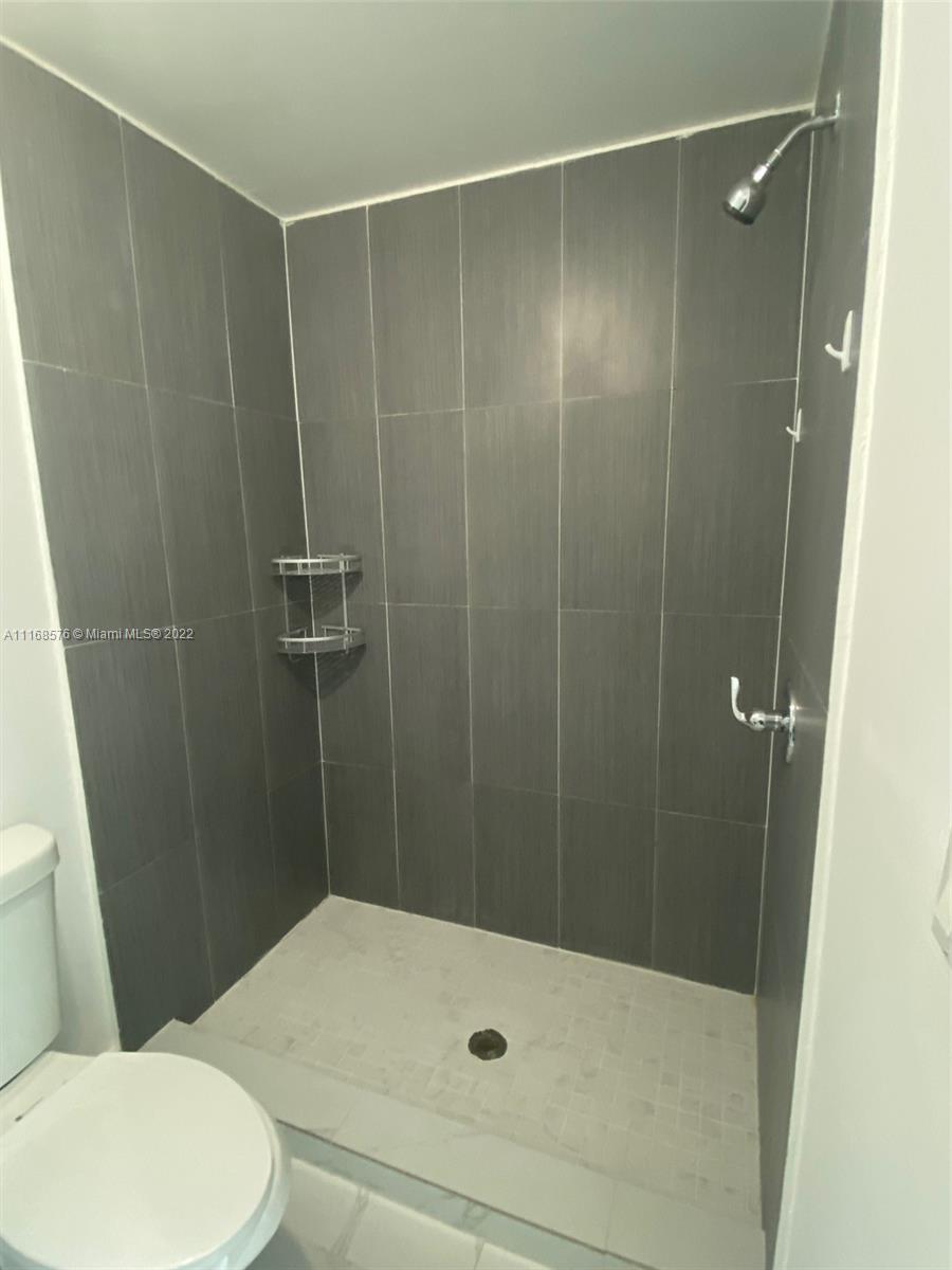 6561 Southwest 30th Street, Unit FRONT Miami, FL 33155 - Photo 4 of 18 a bathroom with a shower and a toilet